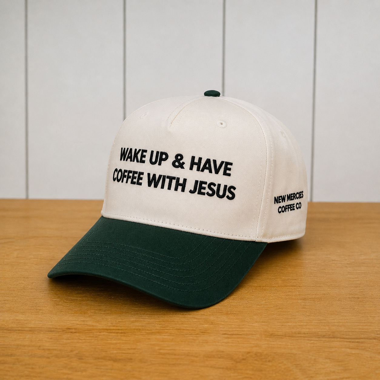 Cap with 'Wake Up & Have Coffee With Jesus' text on a wooden surface